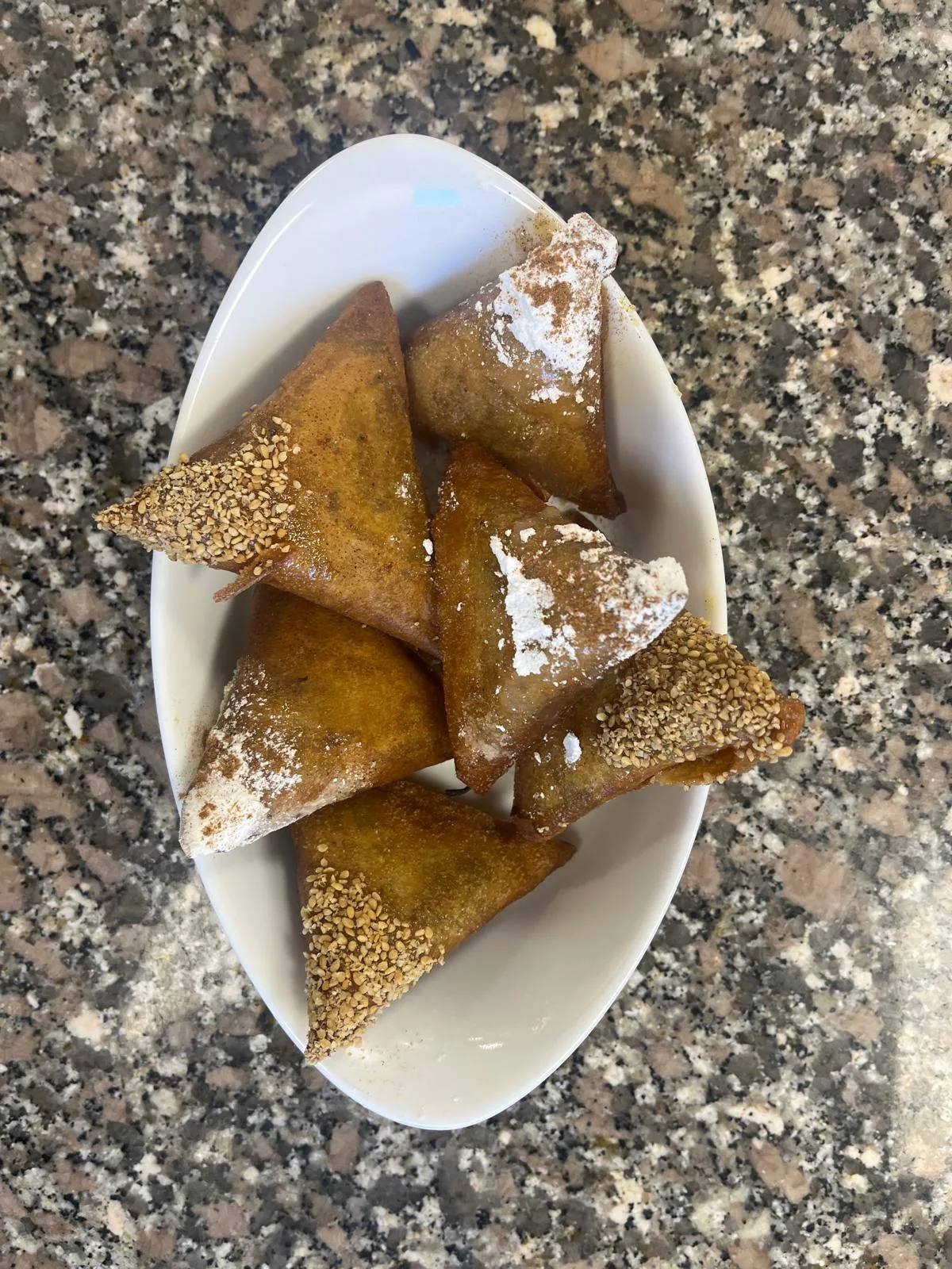 Pâtisseries orientales triangulaires au sésame et au sucre glace